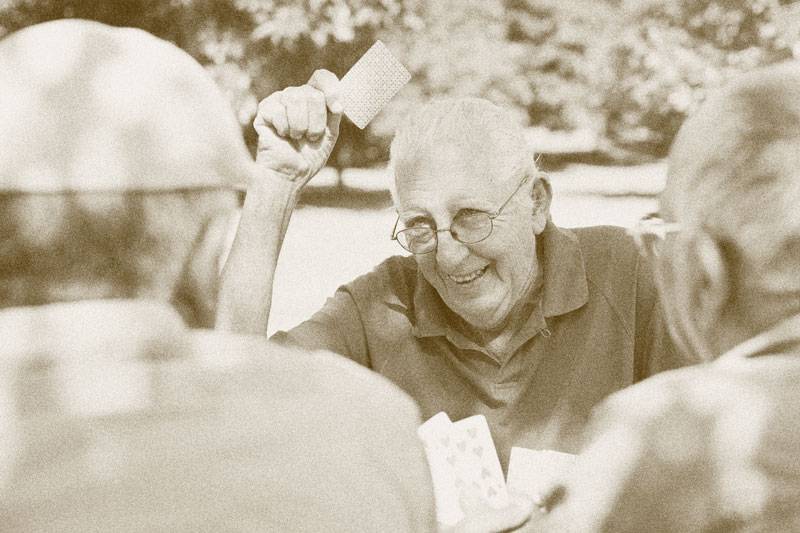 Residents at WLC Carrier Mills playing card games