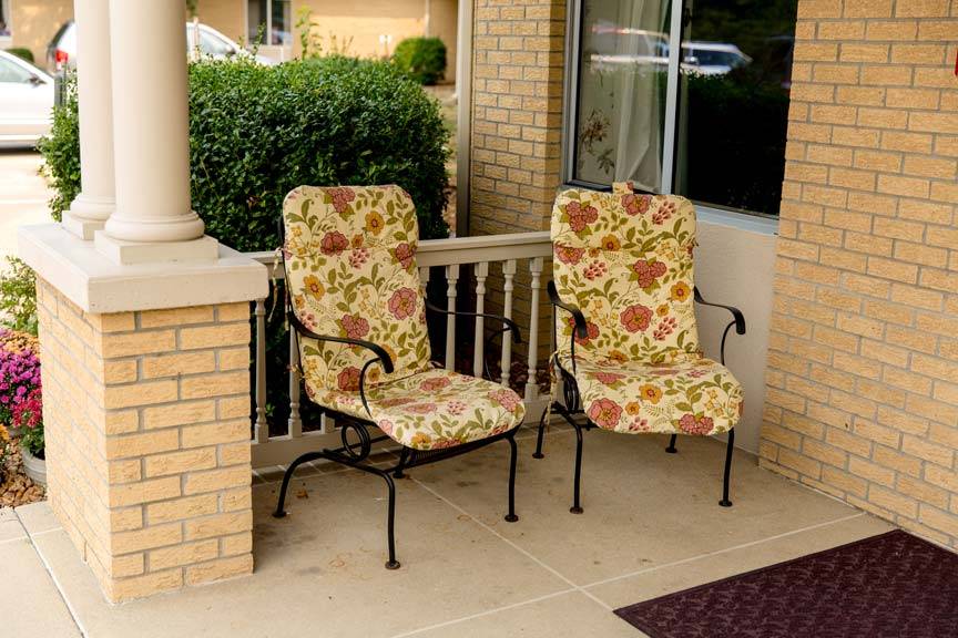 carrier-mills-nursing-rehabilitation-center-img-3 Exterior shot of two porch chairs at the Carrier Mills Nursing and Rehabilitation Center, from the Carrier Mills Gallery
