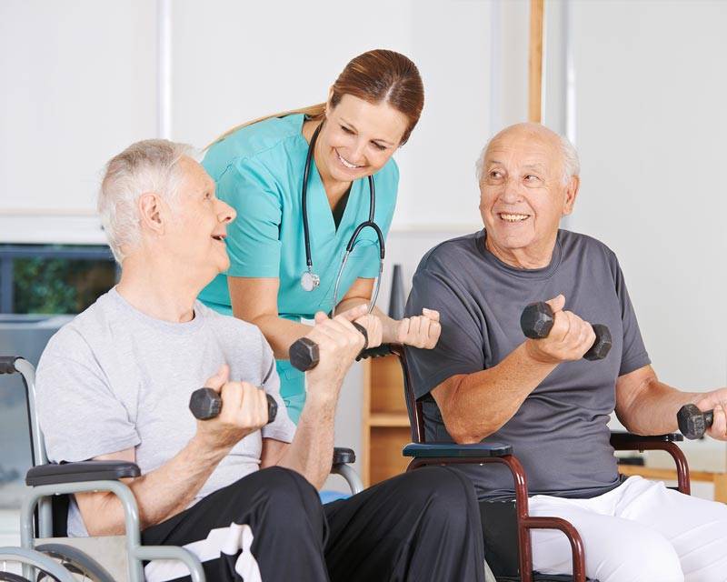 Residents using exercise equipment, a perk among the living features offered at Carrier Mills
